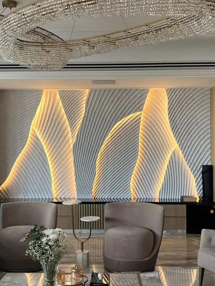 This is what we mean by a feature wall. We used sculpted stone panels with integrated backlighting to create this fluid, wave-like effect. It’s a piece of art that completely defines the living space, offering a dynamic look that changes from day to night.