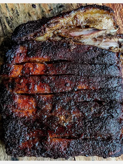 A full rack of my signature Karnivore Ribs, celebrating one year of grilling. This version features a classic Indian spice rub, grilled low and slow for a perfect crust and tender meat.