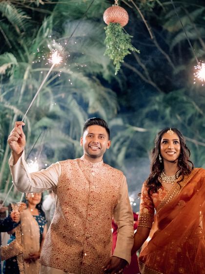 A classic sparkler entry for the happy couple. It's a simple, beautiful way to light up the night and kick off the Sangeet festivities with your loved ones.