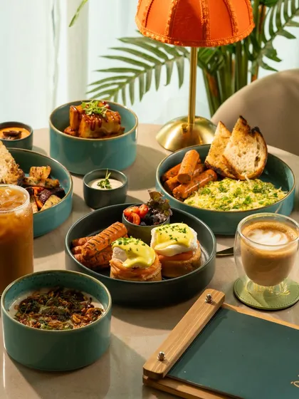 A full English breakfast platter with eggs, sausages, and toast. This classic dish is presented in a modern, stylish way.