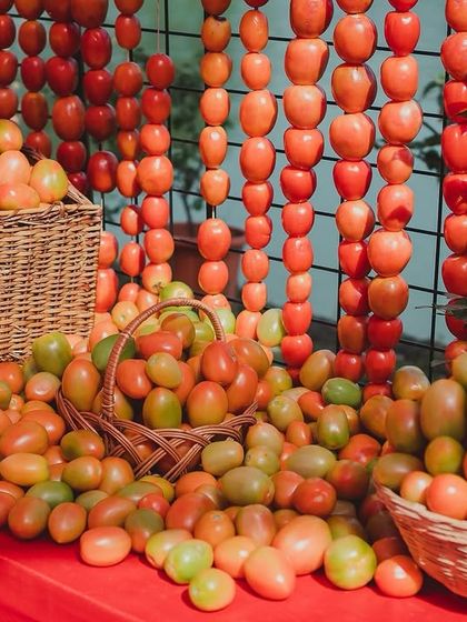 An installation of fresh tomatoes spilling out of wicker baskets and forming a curtain of color. This was a key feature, providing a rich, textured backdrop that was both a visual and sensory delight.