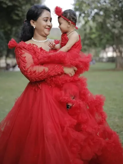 We love creating these special moments. This matching red ruffle gown set for mother and daughter is perfect for birthdays, photoshoots, or any celebration where you want to shine together.