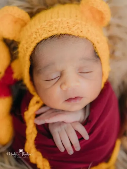 Our very own Winnie the Pooh, just one week old and already so sweet. This close-up captures his peaceful sleep next to his little Pooh bear friend.