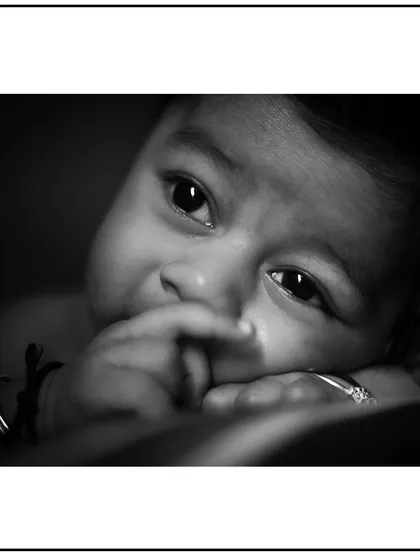 A close-up, artistic black and white portrait capturing the innocent expression of a newborn. These detail shots are a key part of my newborn photography packages.