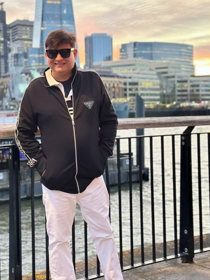 A close-up shot near the Tower Bridge in London, showing the details of my layered, sporty-chic outfit.