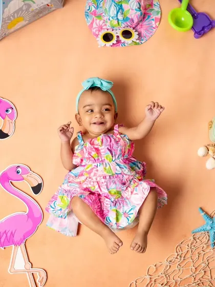 Ready for a day at the beach! This infant photoshoot theme includes everything from flamingos and starfish to a tiny sun hat and sunglasses.