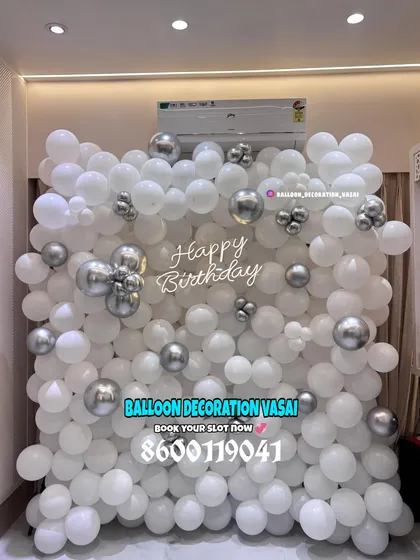 A full balloon wall in white and silver. This creates a stunning, high-impact backdrop for photos at any event.