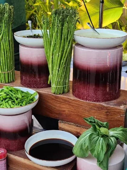 Even our ingredient displays are a part of the decor. Here, fresh asparagus and other greens are presented as an edible arrangement, showcasing the quality and freshness of the produce we use.