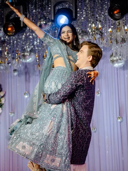 The Sangeet is all about unrestrained joy, and we are there for every moment. This candid shot of the groom lifting his bride is pure happiness, a perfect memory from a night of dance and celebration.