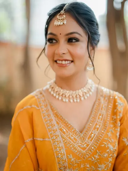 Another shot of this stunning Punjabi look. The makeup is soft and elegant, perfectly complementing her yellow suit and traditional jewelry.
