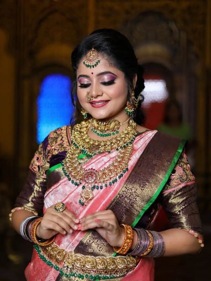 A smiling portrait of the model, looking radiant in our complete bridal set.