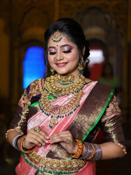 This series features a model in a pink and brown saree, wearing a heavy bridal set with green stone accents, showcasing a complete and regal look.