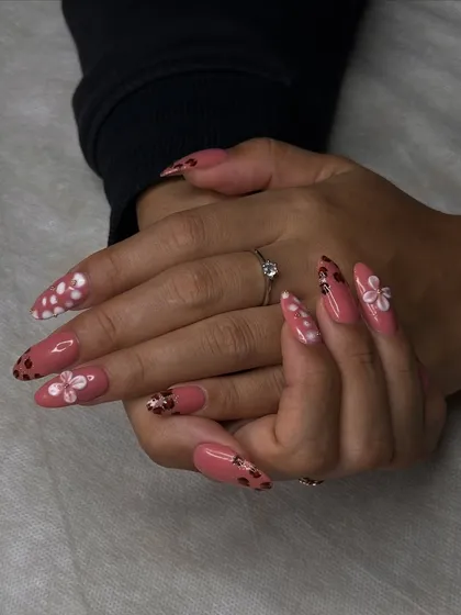 This angle showcases the full set of floral nails, demonstrating how students learn to create a cohesive and beautiful design across all ten fingers.