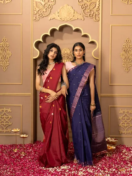 A shot of two models in complementary sarees from Kumaran Silks. This is effective for catalog or campaign work, showing how different pieces from a collection can be styled together.
