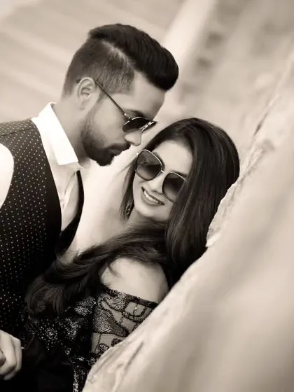 There's a timeless elegance to a black and white photograph. It strips away the noise and focuses on the connection. This classic portrait is all about their effortless style and the quiet confidence they find in each other's arms.