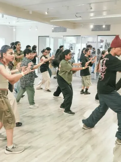 Students learning a foundational hip-hop stance during the Sushan x Shiva Collab Series workshop.