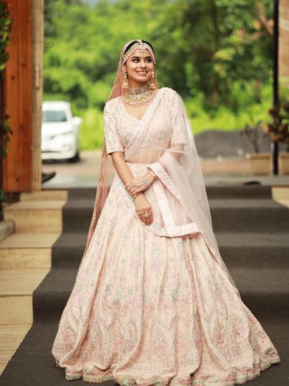 The complete look is a vision of modern elegance. The soft makeup and pastel colors create a dreamy and romantic bridal look.