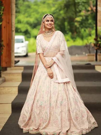 The complete look is a vision of modern elegance. The soft makeup and pastel colors create a dreamy and romantic bridal look.