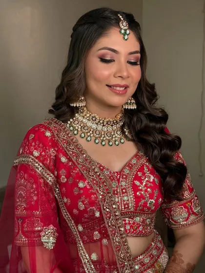 A happy bride, smiling with her eyes closed. This shot captures the pure joy of the moment, with her soft red smokey eye and glowing skin looking absolutely perfect.