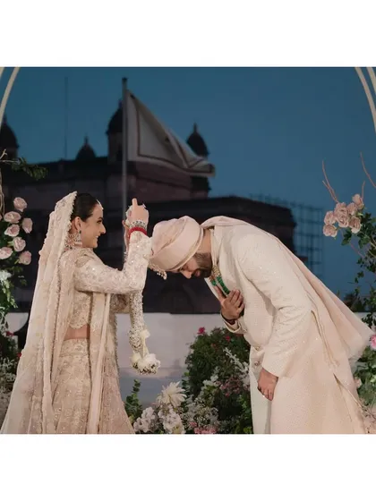 Armaan gracefully bows his head for Nishna during their varmala, with the iconic Gateway of India in the background. This moment, set against the blue hour sky, is a beautiful blend of tradition, respect, and a stunning location.