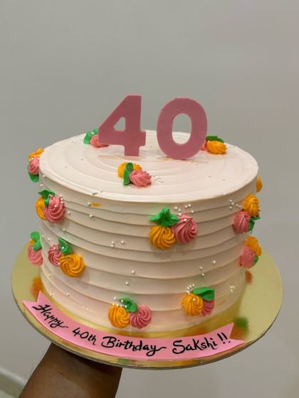 A lovely cake for a 40th birthday, decorated with colorful piped swirls that look like little fruits or flowers. This design is fun, festive, and full of charm.