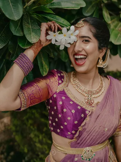 The joy of a half-saree ceremony is unmatched. This custom purple half-saree was designed for a client's special day, featuring a brocade blouse and a flowing skirt that is perfect for celebrating.