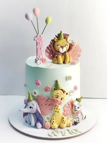 For a little one's first birthday, I crafted this adorable jungle-themed cake. All the cute animals, from the lion to the elephant, are handmade and completely edible, making it a sweet and whimsical centerpiece for a precious milestone.