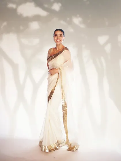 For a movie premiere, we styled Kajol in this luminous white and gold saree. The look is dreamy and ethereal, designed to radiate pure moonshine on the red carpet.