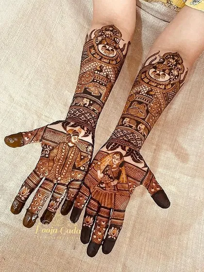 A closer look at the bridal design, showing the intricate details of the bride and groom portraits and the Ganesha figure.