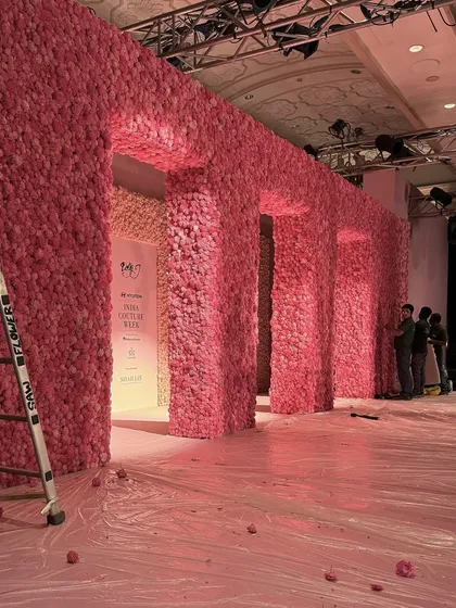 The completed set for Dolly J's show, just before the audience arrived. This wide shot reveals the full scale of the floral walls and arches, a monumental feat of floral engineering.