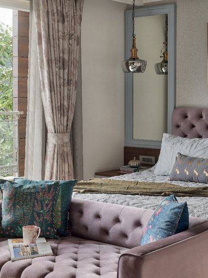 This master bedroom at The Classic Modern Storey balances serenity with subtle energy using tones of lavender and teal. The tufted classical-style bed and multifunctional daybed offer versatility, while a large mirror reflects the outdoor views, integrating nature into the room.