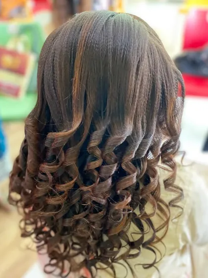 A student's work on open curls using a crimping and curling technique. This creates a unique texture and long-lasting curls, perfect for party hairstyles.