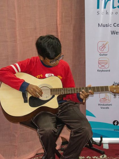 A student plays an acoustic guitar during our open mic session in Sarjapur.