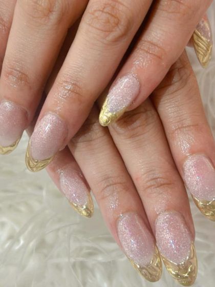 A glamorous take on the French manicure. This set features a shimmery nude base with sculpted gold chrome tips for a liquid metal effect.