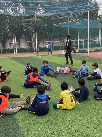 Players stretching in a circle. Sport teaches resilience, teamwork, and discipline, values crucial for character development.