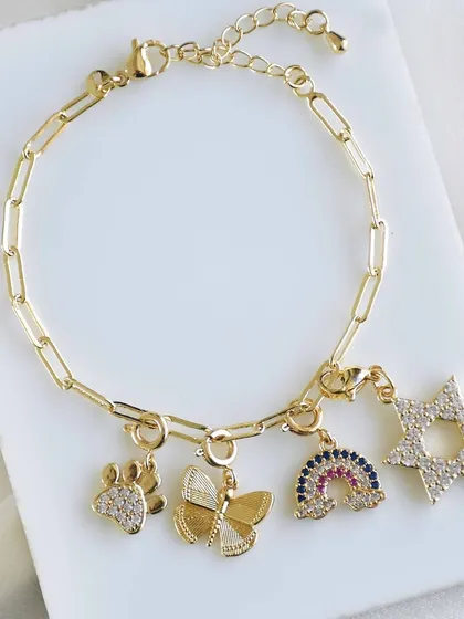 Another beautiful custom charm bracelet, this one featuring a paw print, a butterfly, a rainbow, and a star.