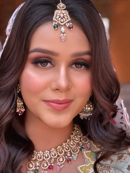 A beautiful portrait of a bride ready for her Haldi ceremony. The makeup is soft and elegant, with defined eyes and a flawless base that glows.