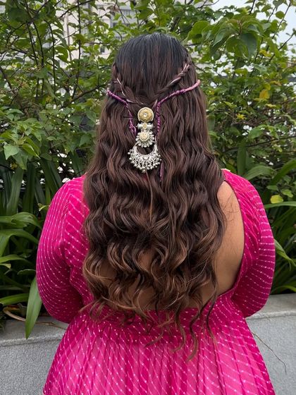Embrace festive elegance with this half-up, half-down hairstyle. The soft, romantic curls are adorned with a statement silver hair accessory, adding a touch of traditional charm to a modern look.