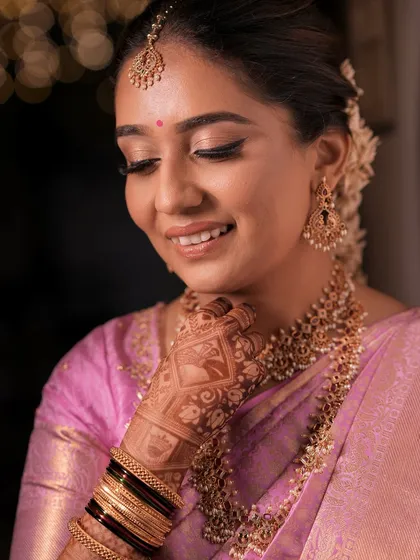 A close-up of Lithika's South Indian bridal makeup. The look features a flawless base, defined eyes with a subtle wing, and a beautiful bindi, all complementing her heritage and finesse.