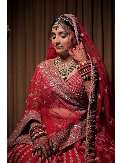 A quiet moment of reflection before the ceremony. The makeup here is designed to look flawless from every angle, with soft smokey eyes and a perfectly defined lip.