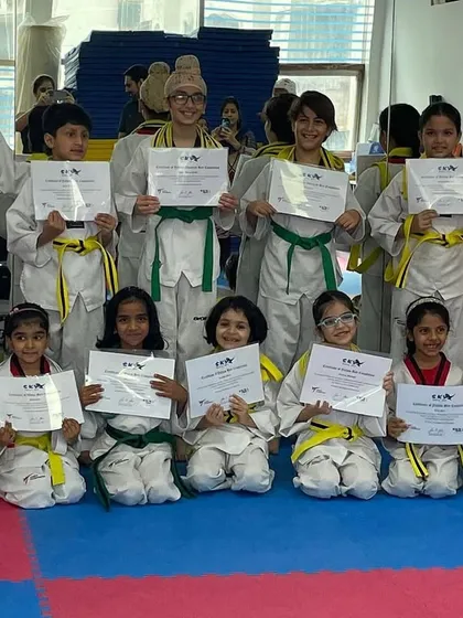A proud moment for our SKYe kids. Posing with their new belts and certificates, these students show the joy and confidence that comes from achieving a new rank in their Taekwondo training.