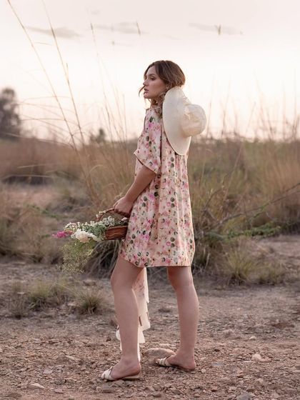 A shot from behind shows the dress in motion as the model walks. This perspective is great for highlighting the fit and flow of a garment from all angles.
