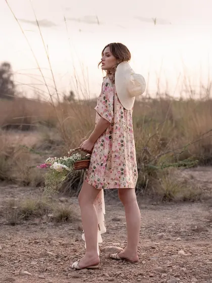 A shot from behind shows the dress in motion as the model walks. This perspective is great for highlighting the fit and flow of a garment from all angles.