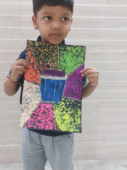 This young artist created a colorful cupcake using a pointillism-inspired technique. It's a great example of how we explore different art styles.