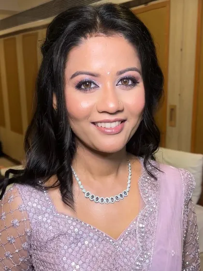 A close-up portrait of my sister's reception look. The shimmering lilac eyeshadow and flawless base create a dreamy and elegant finish, perfect for her special night.
