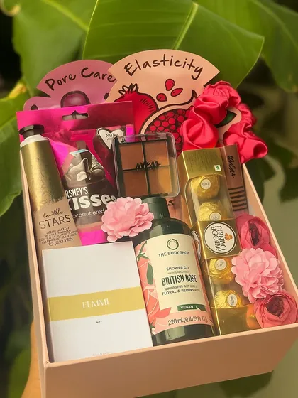 This hamper is designed to pamper your sister or bridesmaid. It's packed with essentials like face masks, a Nykaa eyeshadow palette, The Body Shop shower gel, Ferrero Rocher, and a personalized Zara perfume.