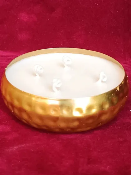 A simple yet elegant hammered golden urli candle with four wicks.