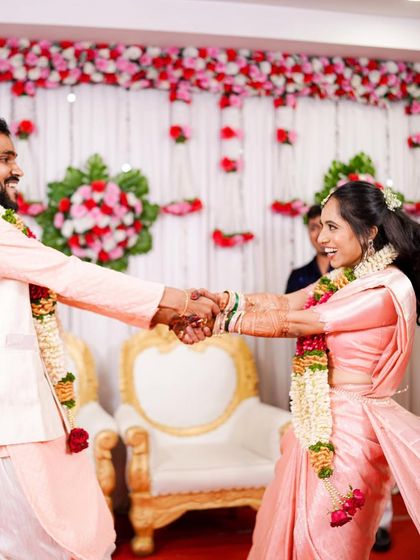 This couple is lighting up their engagement party. The bride's traditional South Indian attire is styled for movement, allowing her to dance and celebrate freely.