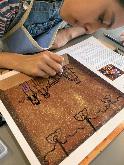 This student is carefully drawing figures in a style reminiscent of Picasso's line drawings.