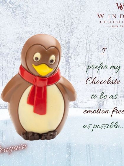This adorable chocolate penguin is ready for winter with a bright red scarf, made from milk and white chocolate.